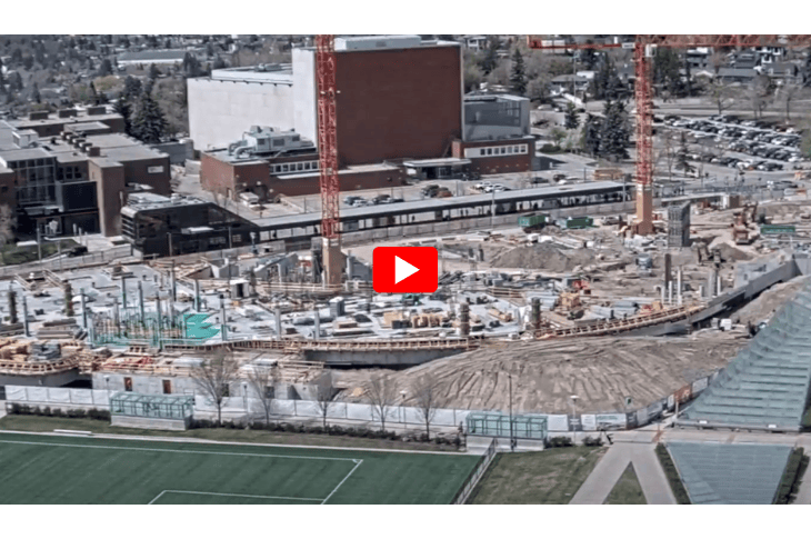 play button over an image of a construction site