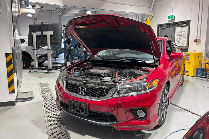 red car in SAIT automotive shop with the hood up