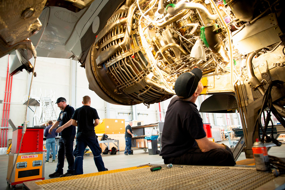Technicians working on the engine