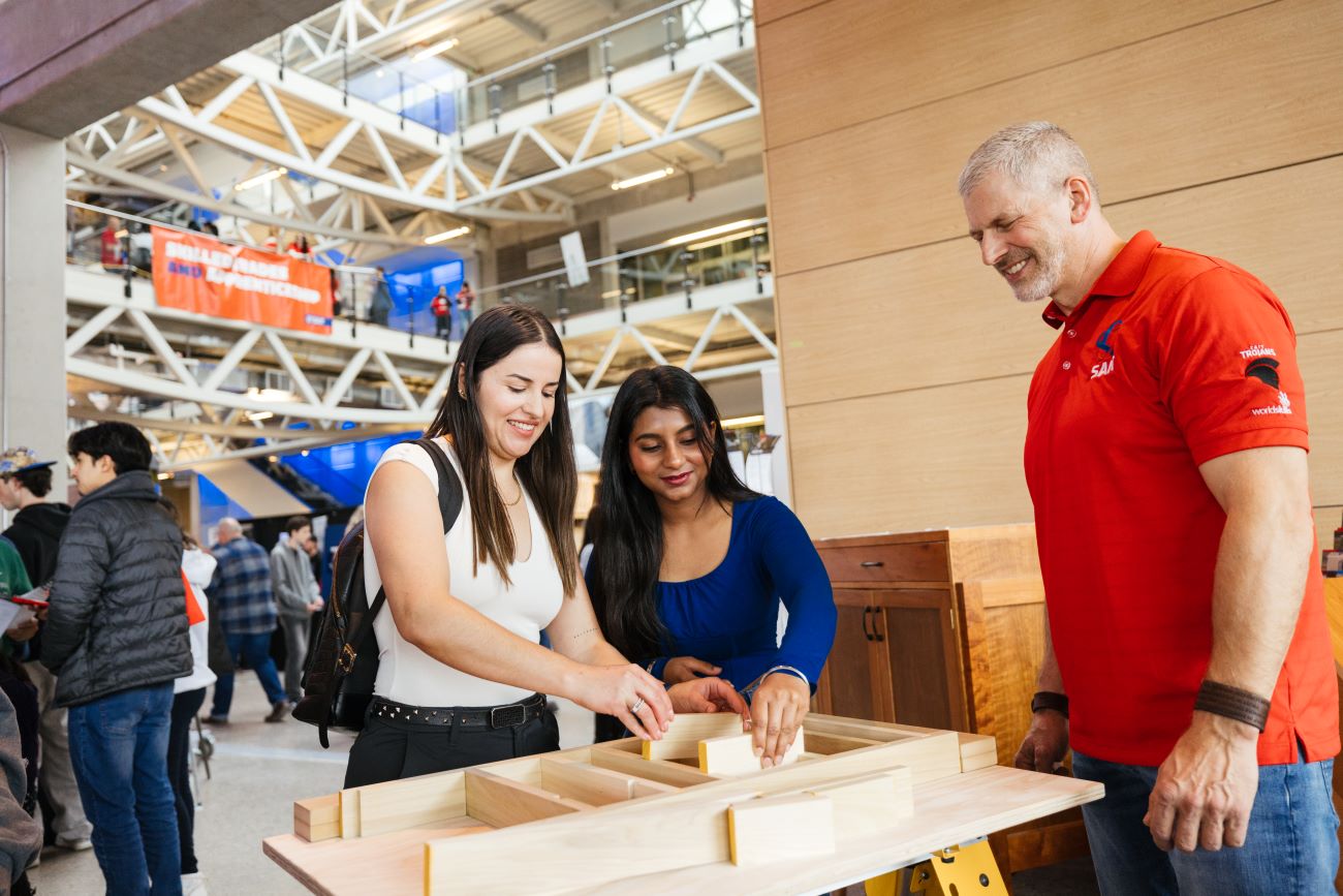 Two students trying a skill at open house