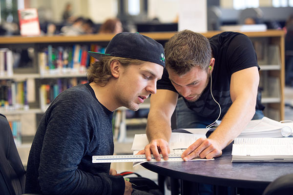 Two SAIT apprentices study in the Reg Erhardt Library.