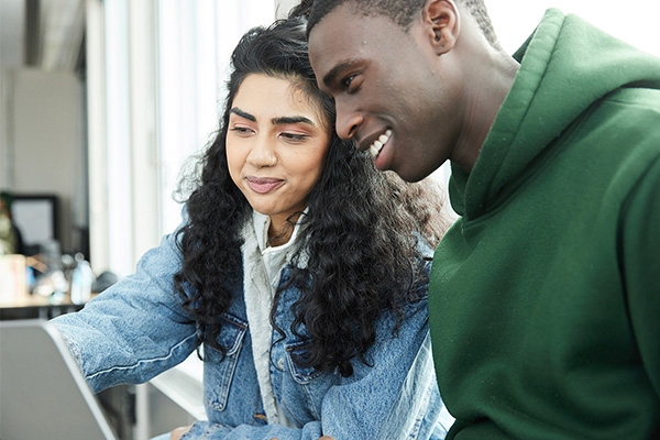 Two students looking at a screen