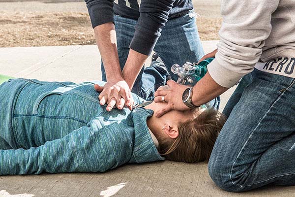 A man on the ground receiving CPR