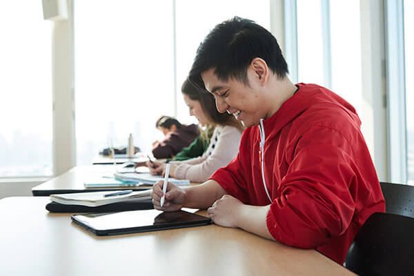 Student taking notes on a tablet