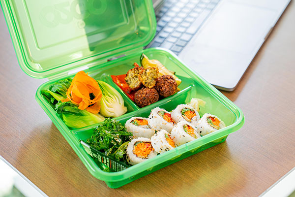 A green bento box with food