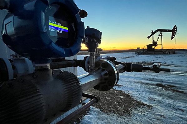 The FLOW MK3 is pictured in the foreground with a pumpjack and the sunset in the distance.