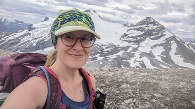 Photograph of Christ Nichols hiking in the mountains.