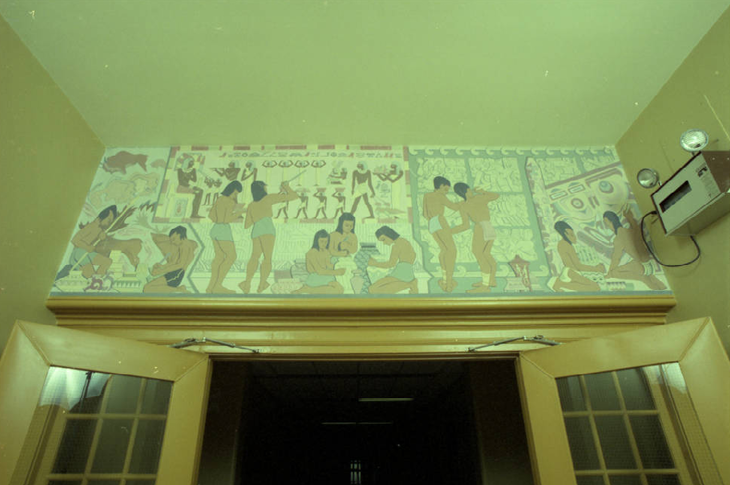 Mural titled Evolution of record keeping can be seen above the doors of the entrance to the third floor from the eastern stairwell in Heritage Hall.