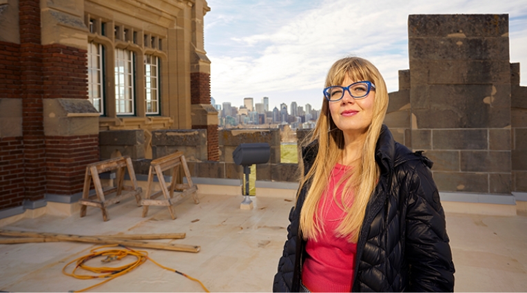 Tracy Wylie standing on the rooftop of Heritage Hall