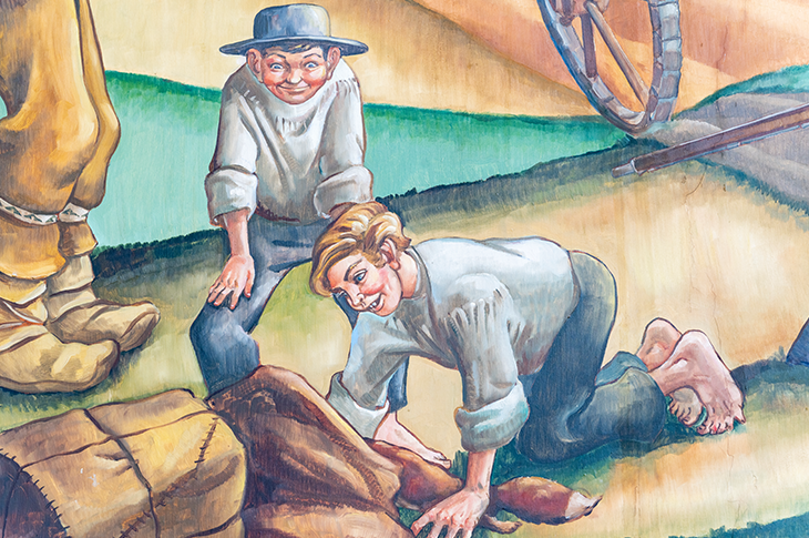 Close up of boys on mural playing.