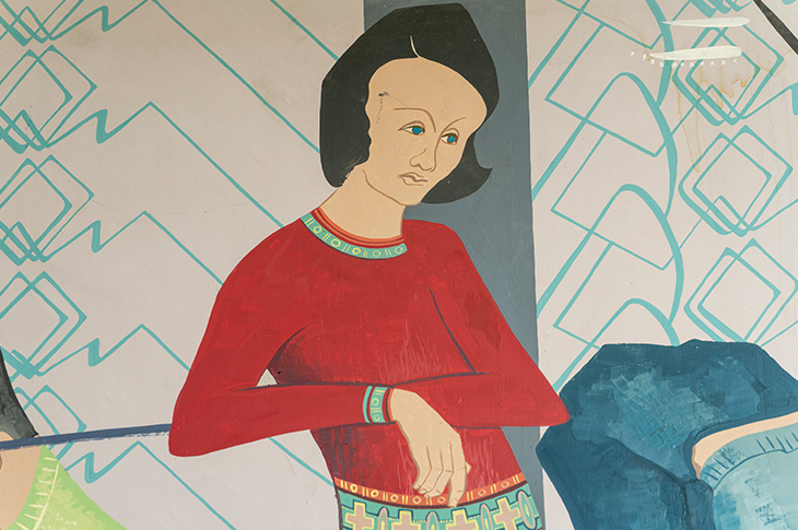 Close up of woman or girl on mural in a red sweater.