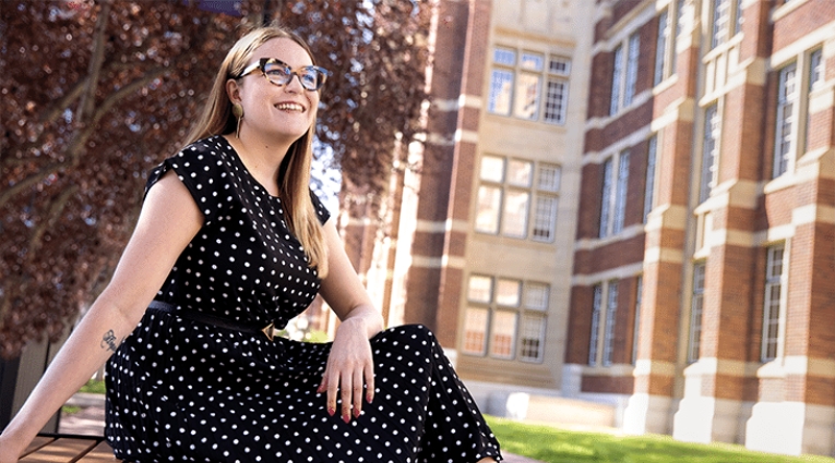 Madeleine MacDonald sitting on a bench looking off camera