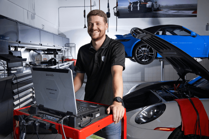 automotive technician with computer and car