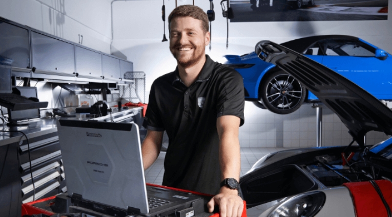 automotive technician with computer and car