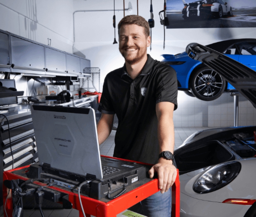 automotive technician with computer and car