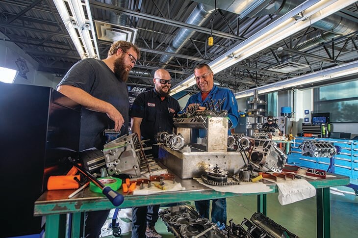 Instructors and student working in the Clayton Carroll Automotive Centre