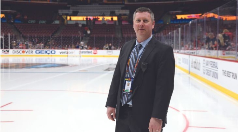 Mike Craig in a suit on the ice surface at the All Stars weekend