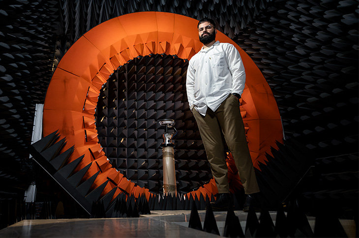 Man standing in front of orange circle in sound proof room