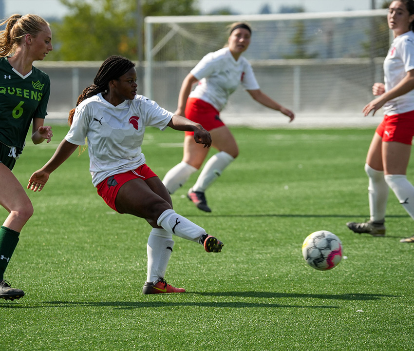 girl kicking soccer ball