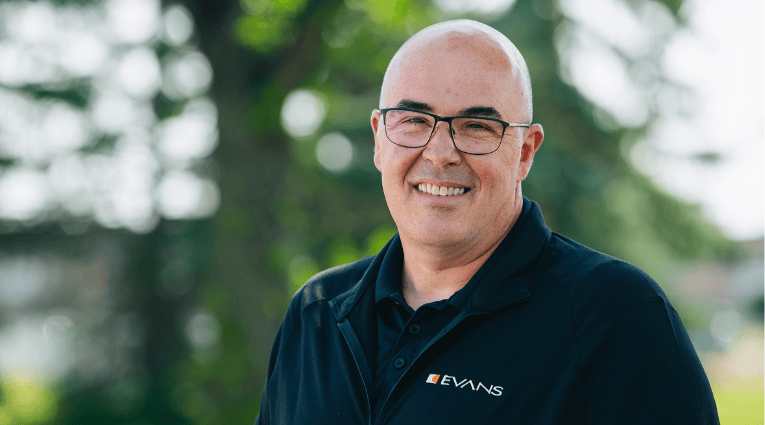 man in black shirt and jacket outside smiling