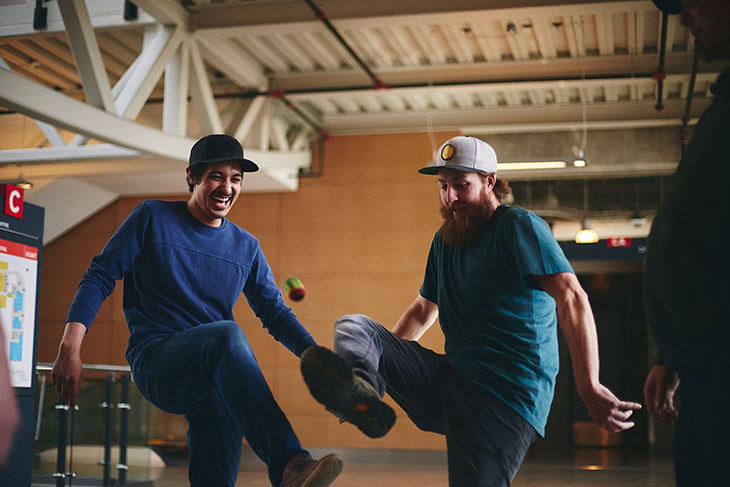 Two men playing hacky sack