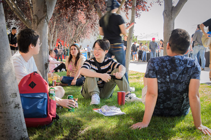 Students sitting in field on SAIT campus