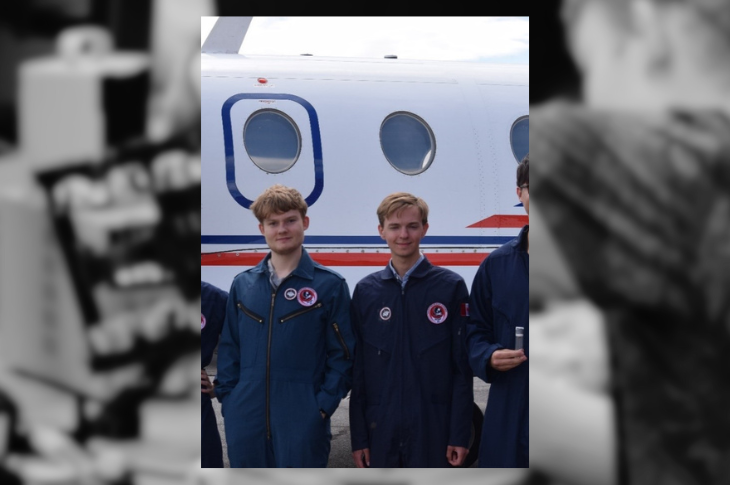 two members of the supernovas stand in front of the Falcon 20