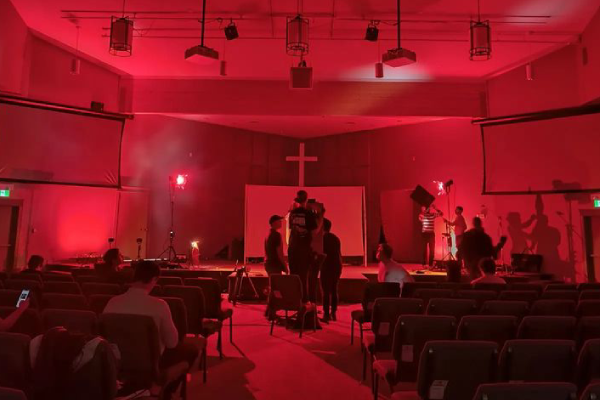 A chapel is lit with red light for a film project.