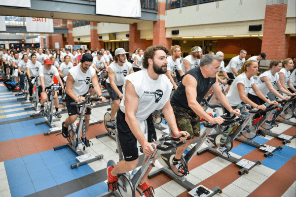 SAIT's Irene Lewis Atrium is filled with hundreds of spin bikes with SAIT employees riding them in workout clothes.