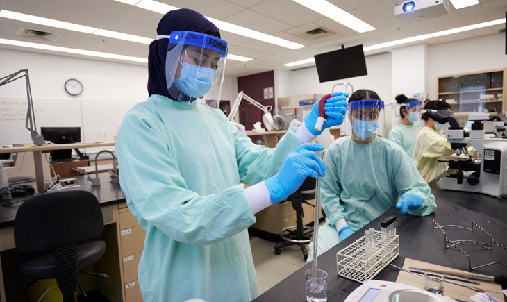Two students train in medical laboratory. 