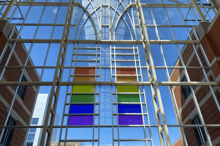 A window in Irene Lewis Atrium with rainbow stained glass.