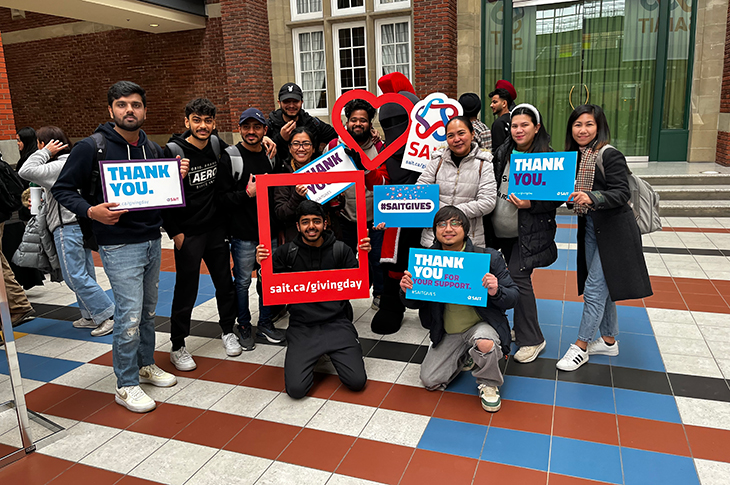 A group of SAIT students smile on Giving Day 2024.