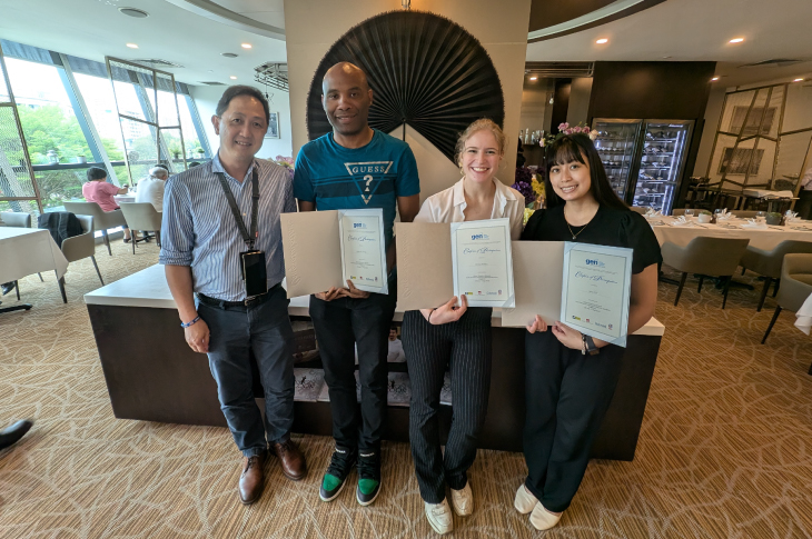 Students stand proudly holding their GEN certificates of participation at ITE College West.