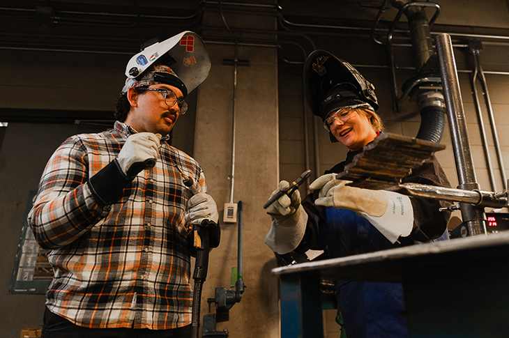 Welding Engineering Technology student Caleb Reed and Welding Instructor Tanya Reed share a hands-on learning moment,