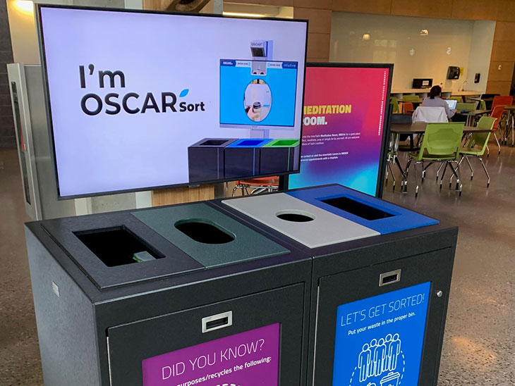 waste stream bins with a large monitor that reads, I'm OSCAR