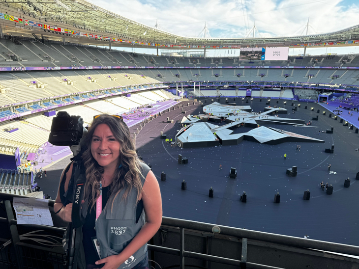 Candice Ward is holding a camera at the Paris Olympics Closing Ceremony