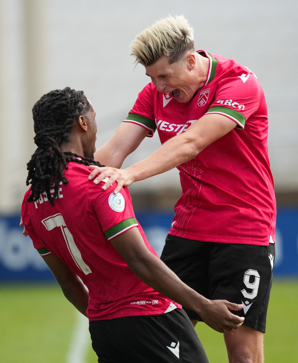 two soccer players are celebrating