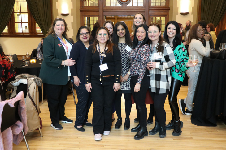 A group of women posing together at a social event.